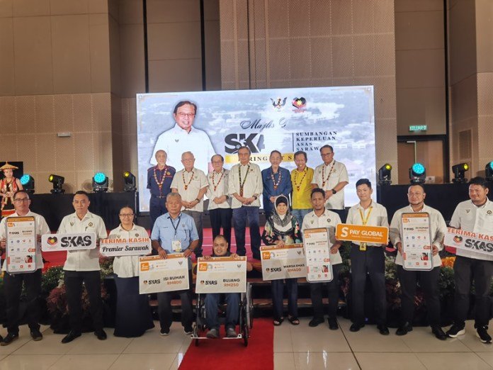 Abang Johari (on stage, centre) together with other distinguished guests in a photo with recipients of SKAS at Serian Convention Centre on Feb 18, 2025.
