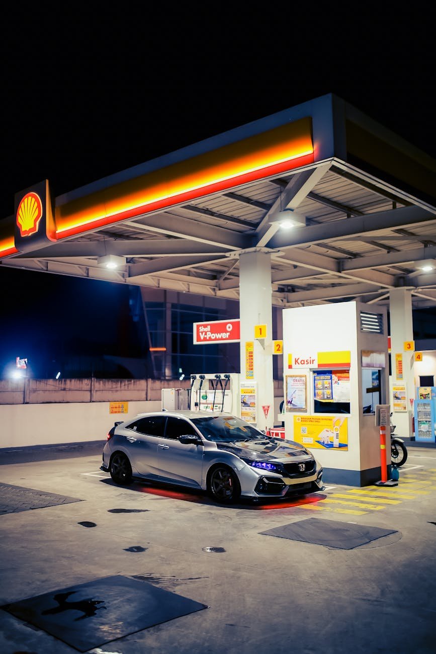 silver honda civic at a shell gas station at night